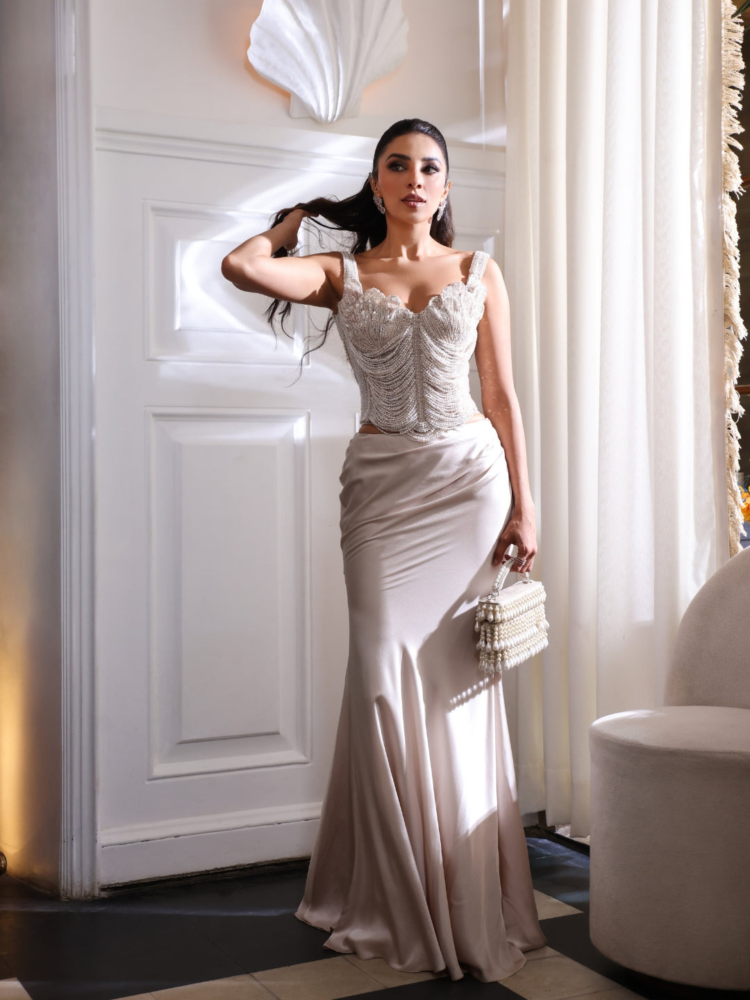 An pearl embellished corset paired with a fluid satin skirt.An pearl embellished corset paired with a fluid satin skirt.