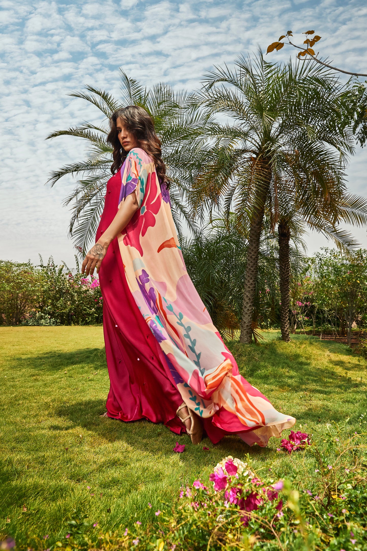 Foral printed cape paired with cerise pink bias dress.
