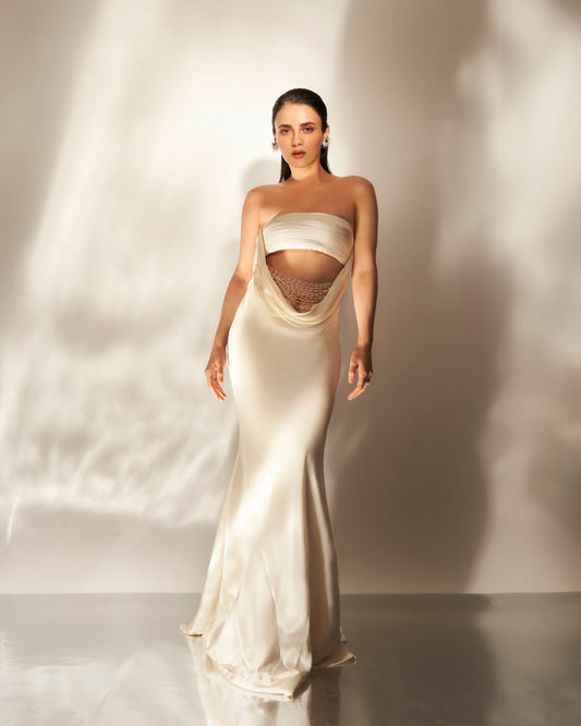 Ivory cowl gown with embellishments.