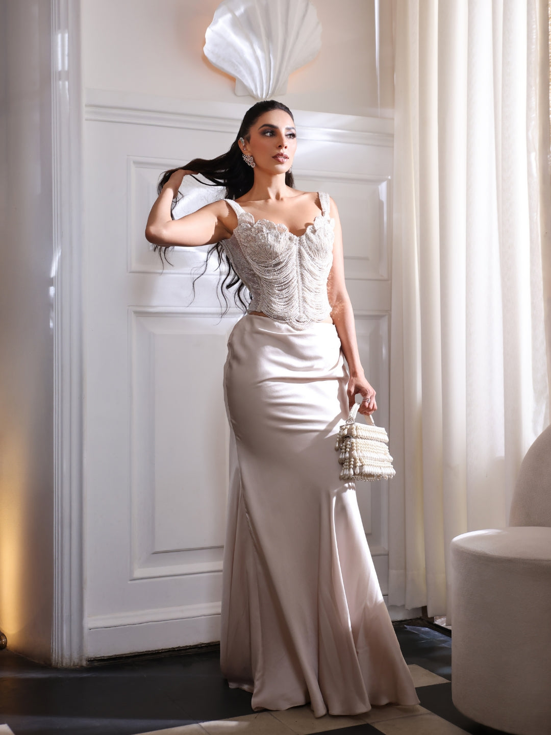 An pearl embellished corset paired with a fluid satin skirt.An pearl embellished corset paired with a fluid satin skirt.