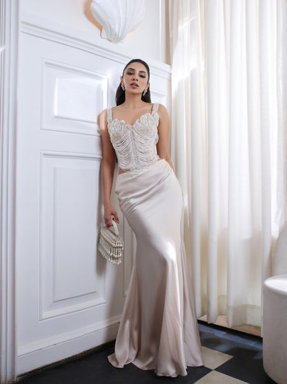 An pearl embellished corset paired with a fluid satin skirt.An pearl embellished corset paired with a fluid satin skirt.