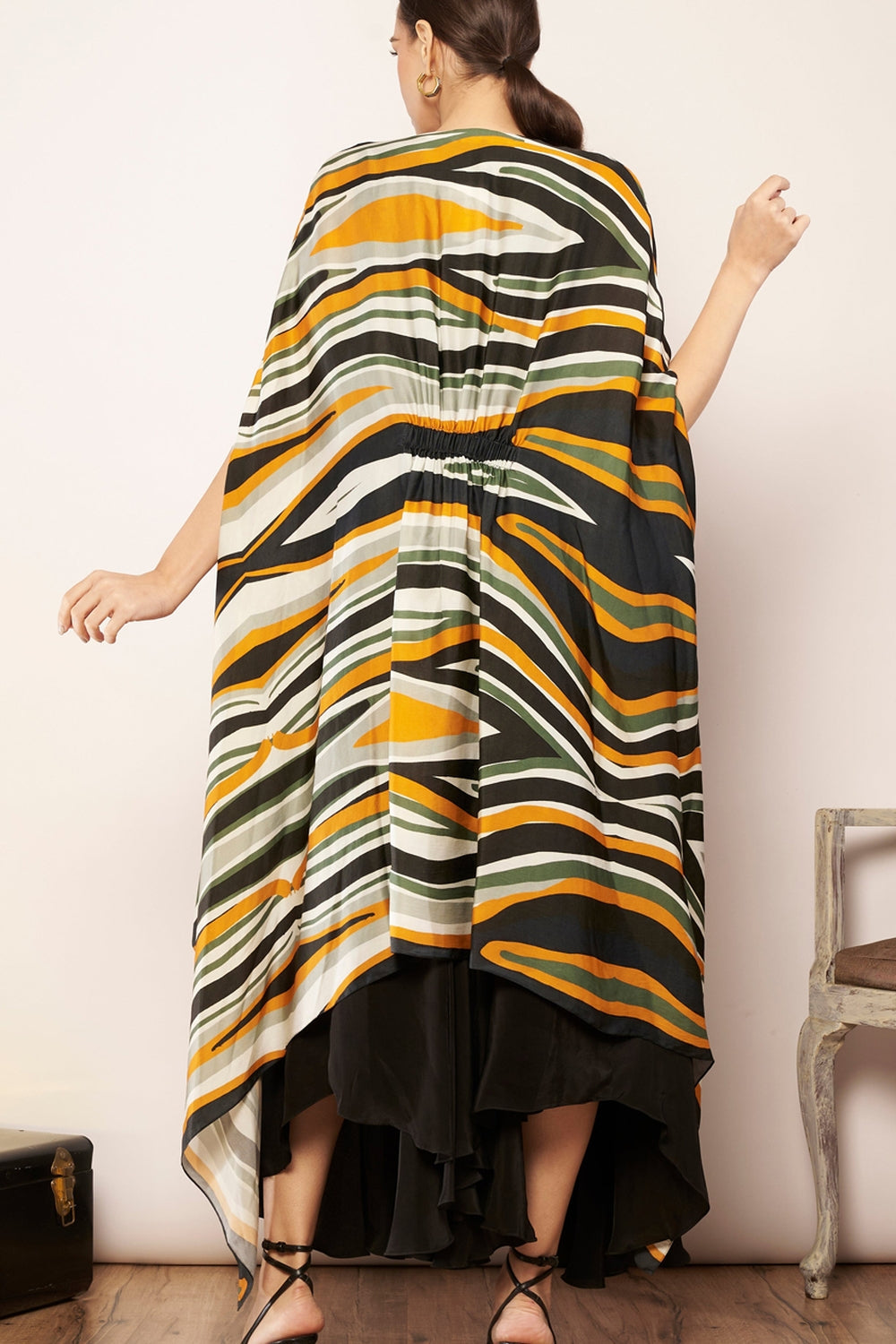 Printed cape with tucks detailing.