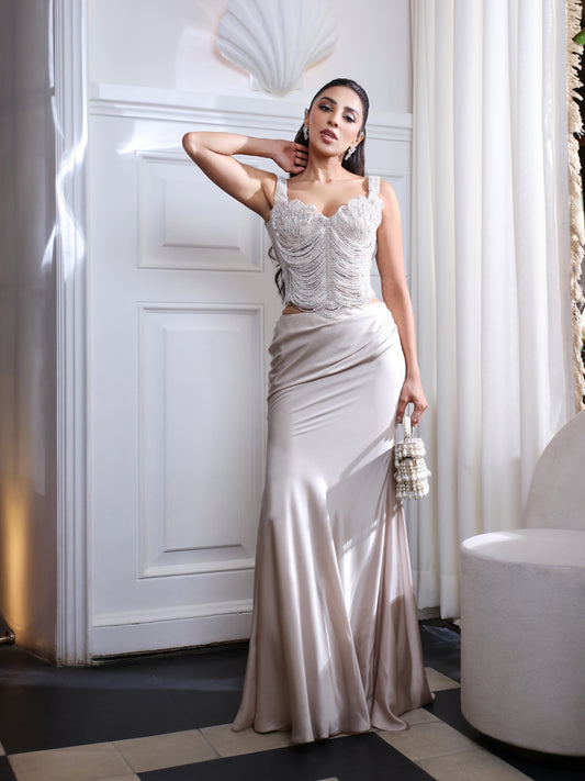 An pearl embellished corset paired with a fluid satin skirt.An pearl embellished corset paired with a fluid satin skirt.