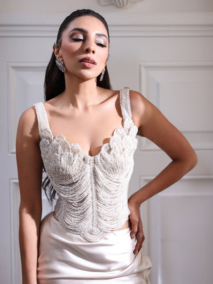 An pearl embellished corset paired with a fluid satin skirt.An pearl embellished corset paired with a fluid satin skirt.