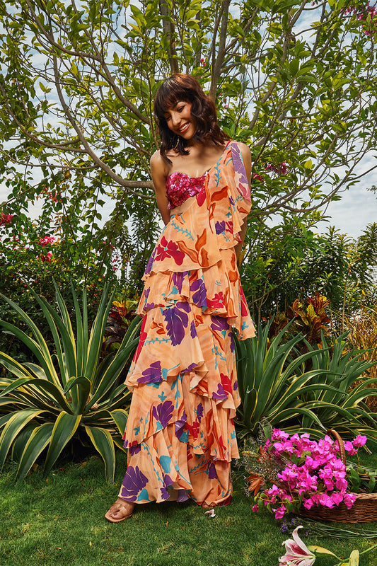 Cerise pink embellished bralette paired with floral printed ruffle saree.