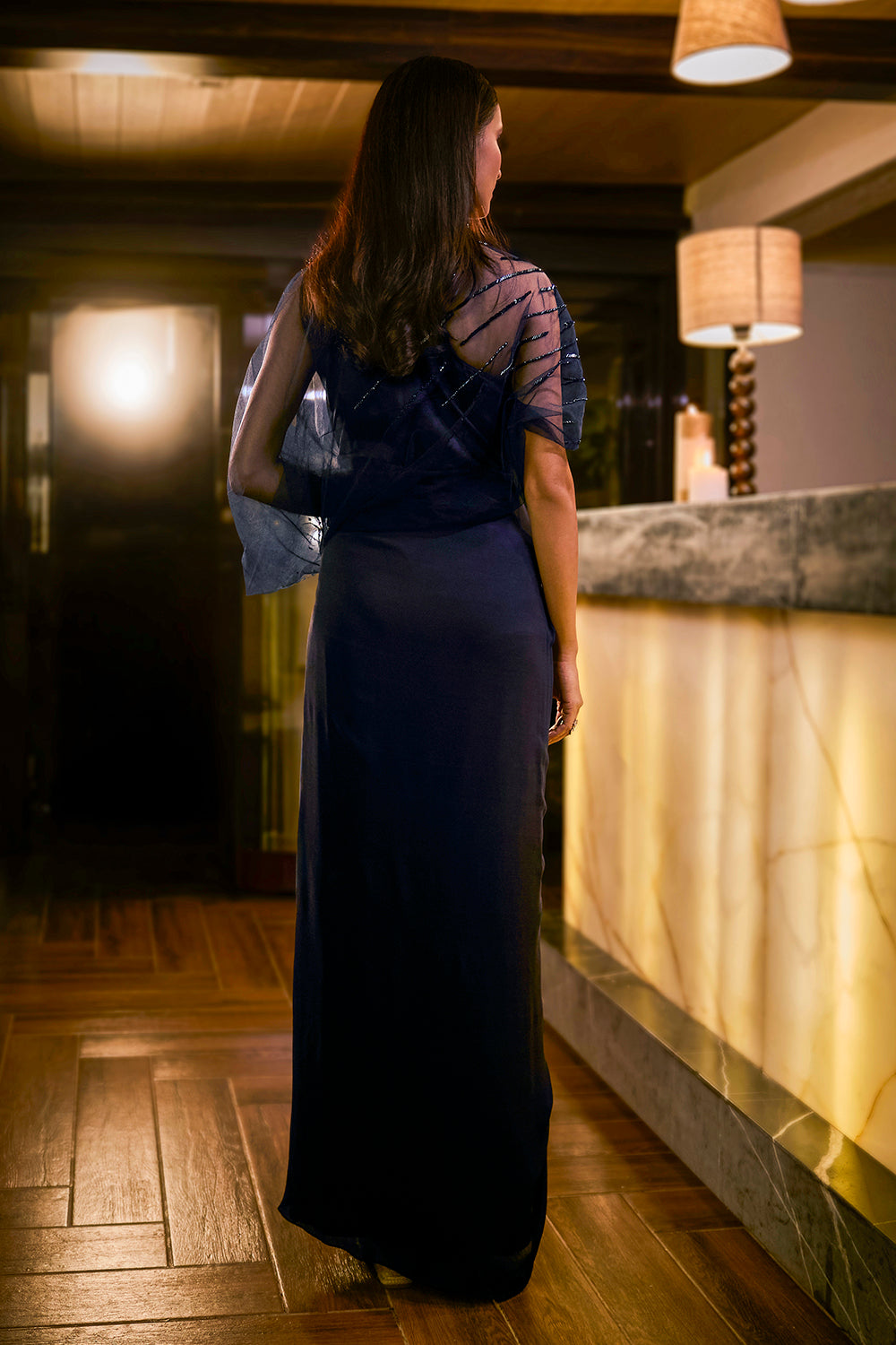 Midnight Blue jumpsuit with sheer sleeve and draped silhouette