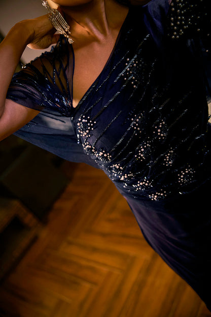 Midnight Blue jumpsuit with sheer sleeve and draped silhouette