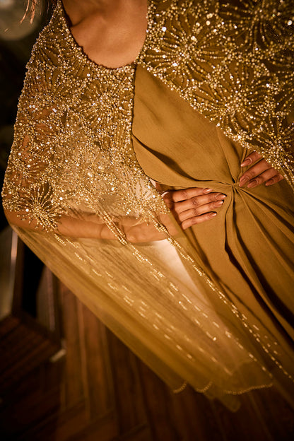 Olive green dress paired with an embellished sheer cape