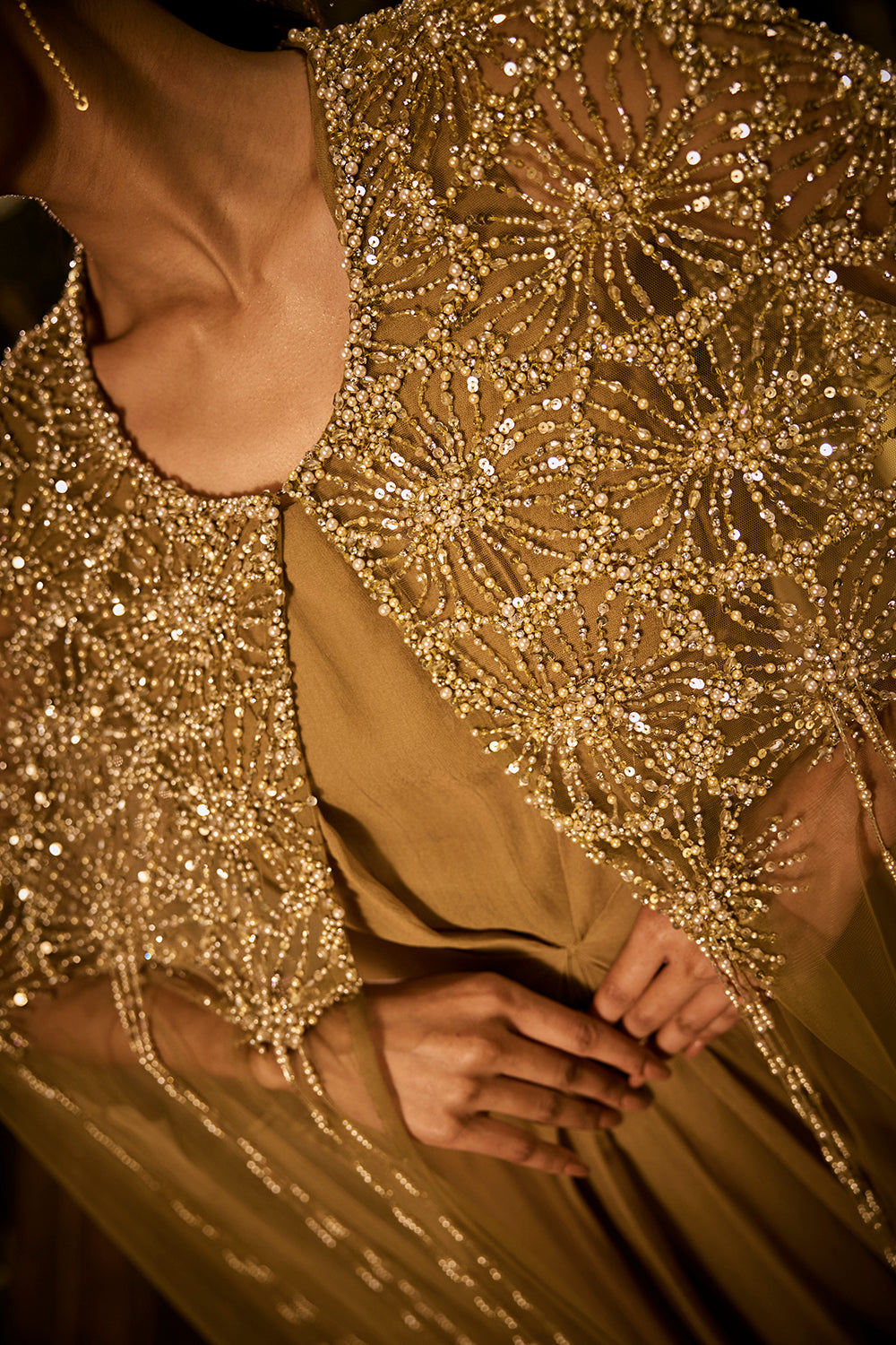 Olive green dress paired with an embellished sheer cape