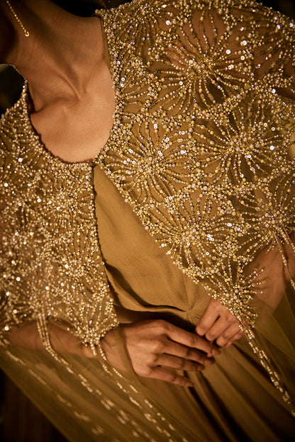 Olive green dress paired with an embellished sheer cape