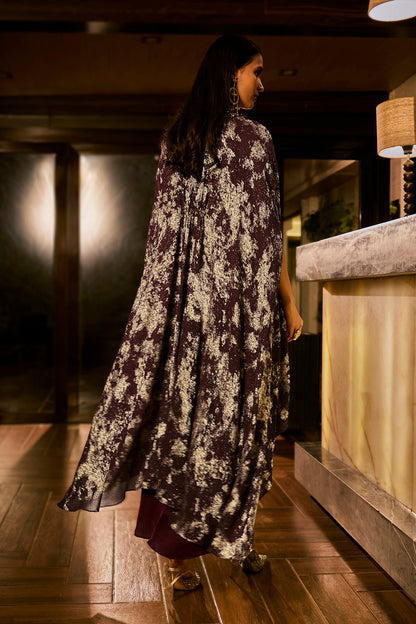 Ruched knot dress with a gold crushed foil cape