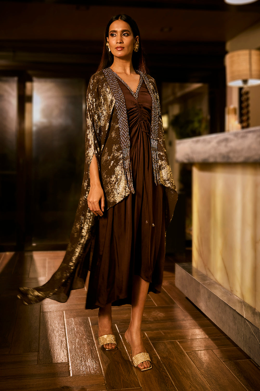 Ruched knot dress with a gold crushed foil cape