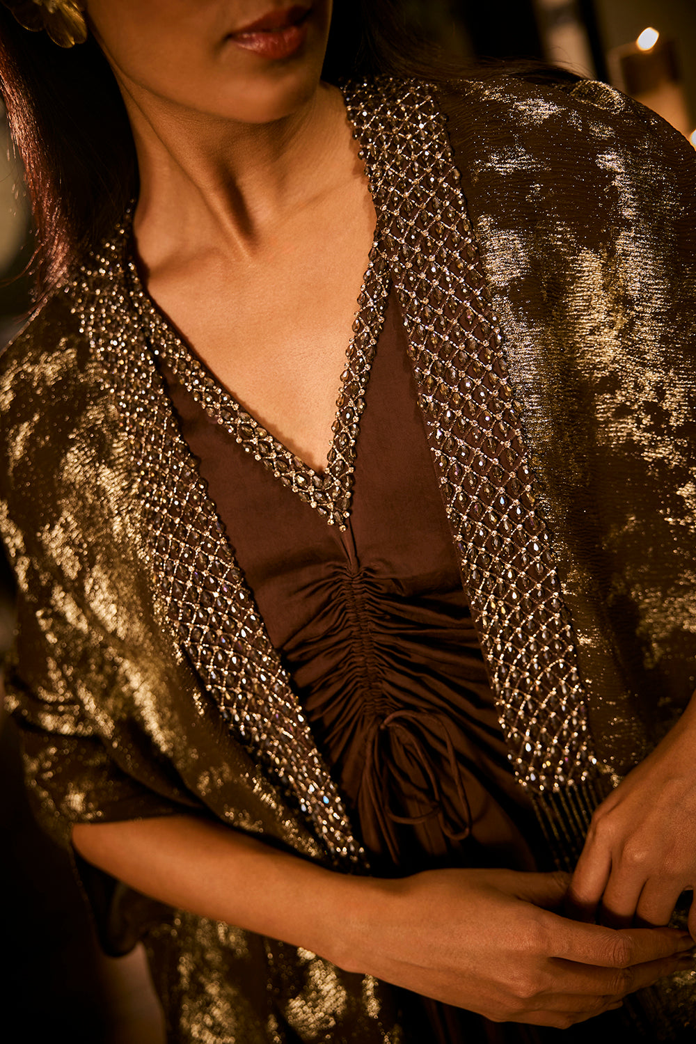 Ruched knot dress with a gold crushed foil cape